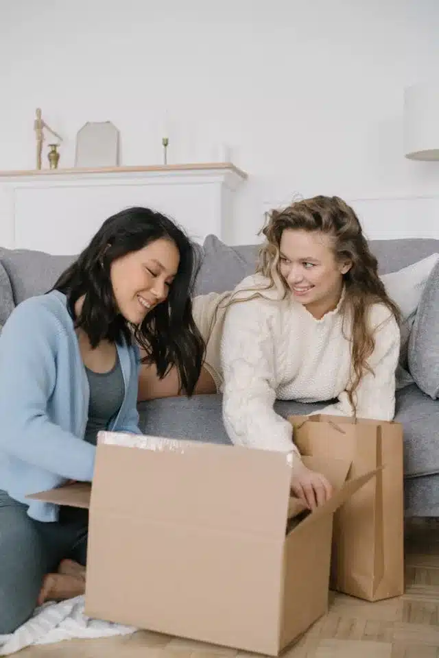 How to send a parcel: a practical 7-step guide (online, dot/locker or post) 2 Two women unpacking boxes together.